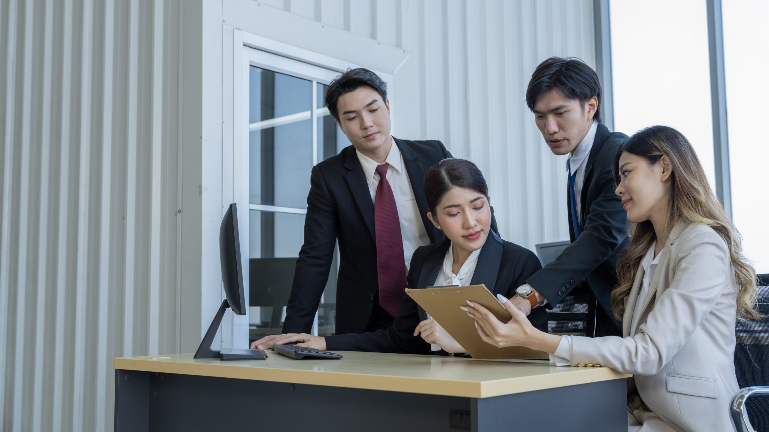 A group of young Asian businessmen Talking and planning work happily and have fun. at the company's office